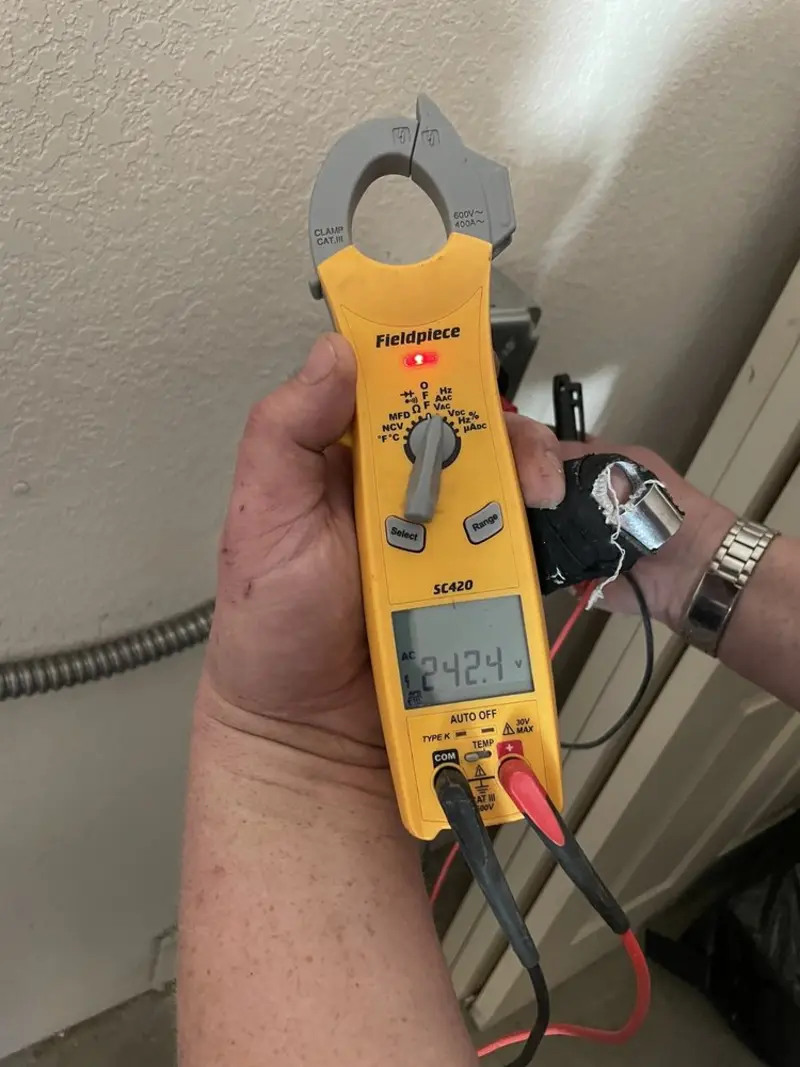 Voltage testing with clamp meter during Electrical Installation Services in Hazlehurst